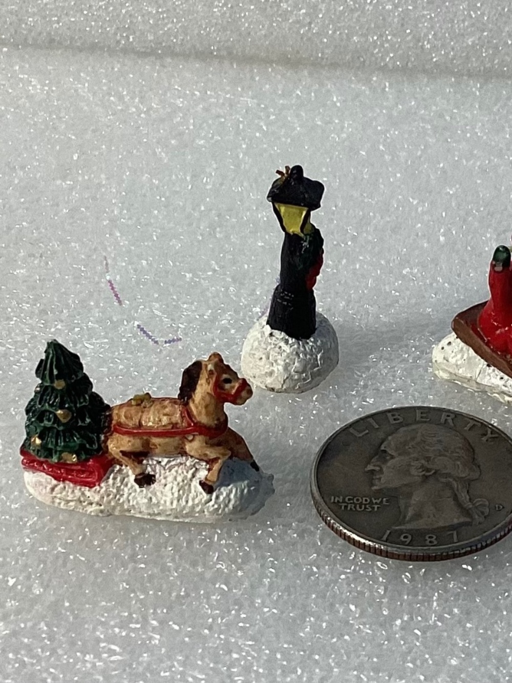 Miniature Christmas village trees, fences, people